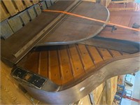Antique baby grand piano on pallet