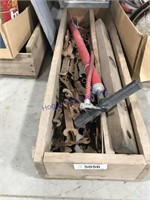 long wood box with old wrenches and hand pump