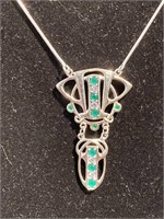 Necklace with emerald colored stones marked
