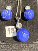 Lapis pendant and earrings set with crystals on a