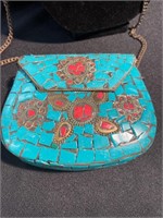 Purse with turquoise and carnelian inlay on a