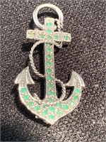 Anchor pin with aquamarine colored cut stones