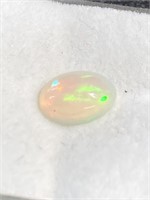 Opal with lots of red and green fire. About a