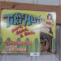 The tiki hut tin sign