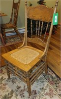 PRESSED BACK WOODEN CHAIR W/CANE SEAT