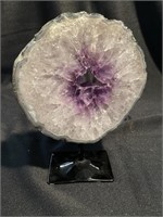 Polished amethyst display piece on a stand. 8