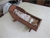 small doll cradle w/porcelain doll