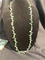 Green colorized pearl and clear stone necklace.