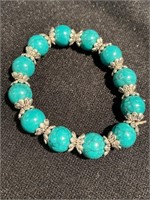 Bracelet with turquoise colored beads on a