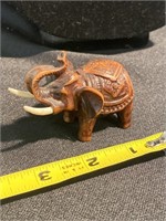 Intricate hand carved wooden elephant with tasks