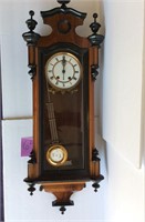 Tall wooden wall clock with pendulum