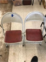 2 small metal folding chairs