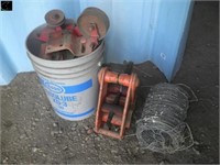 Small Roll of barbed wire, plastic pail of pulleys