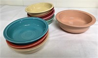 Seven fiesta Ware bowls and one serving bowl