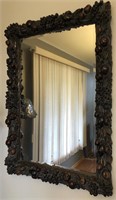 Mirror with carved wood frame.