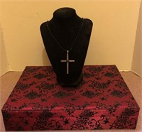 Red satin box with black velvet detail. Necklace