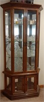 Wood lighted curio cabinet with glass shelves.
