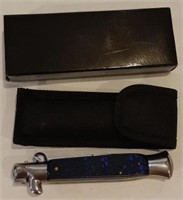 Switch blade knife. In box with sheath.
