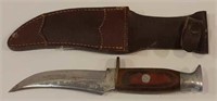 Rose hand made buck knife with leather sheath.