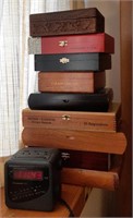 Lot of cigar boxes and alarm clock.