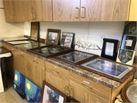 Large Assortment of Prints on Countertop