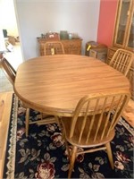 Dining room table with 4 chairs and area rug