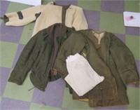 Assortment of military issue clothing and coats.
