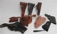 Assortment of leather and canvas gun holsters and