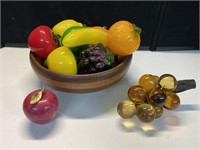 Wooden bowl full of glass fruit, marble apple