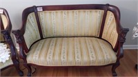 EMPIRE SETTEE WITH CARVED FACE ACCENTS CIRCA 1920