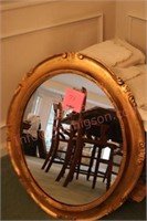 Gold oval mirror, table linens