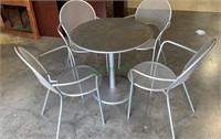 Silver metal patio table with four matching arm