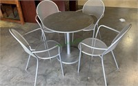 Silver metal patio table with four matching arm