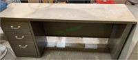 Long and narrow metal desk, with three drawers on