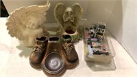 Two angel figures, bronze baby shoes, and nine