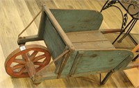 Antique wooden wheelbarrow in milk house