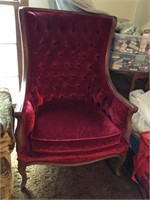 Red velvet wing back chair