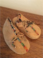 Infant sized handmade leather shoes with sewn on
