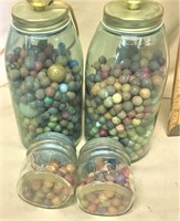 Large lot colored clay marbles in jars