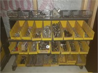 Rack with bens of miscellaneous bolts screws and