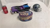 Toy car and Dallas Cowboys bank with a candy tin