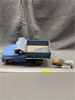 Blue metal dump truck and small trucks