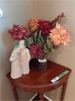 Decor vase with artificial flowers and statue.