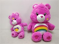 pair of pink Care Bears different sizes and logos
