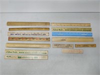 lot of vintage rulers with advertisements on them