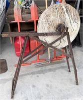 Sandstone grinding wheel on metal stand