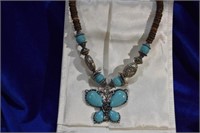 Silvertone &faux turquoise butterfly necklace