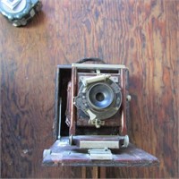 Antique box camera with tripod.