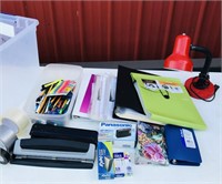 Tote of office supplies and two desk lamps