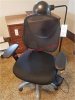 Rolling desk chair and black floor lamp